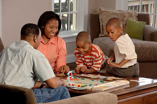 family in house playing games Playing games is a great way for people to build connections. It's common for families and friends to have "Game Nights."