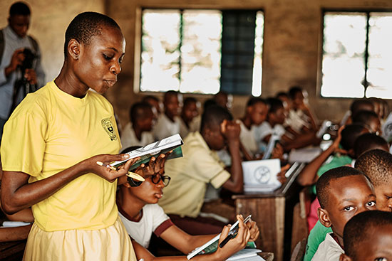 A black girl reading a book in a classroom Ayeshaitu's life proves that the struggle is worth the achievement. Many other girls pursue an education and learn important skills like reading.
