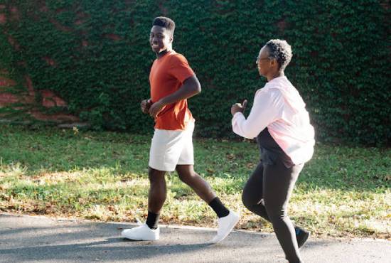 Son and Mom Jogging Two people jogging together on a path outside