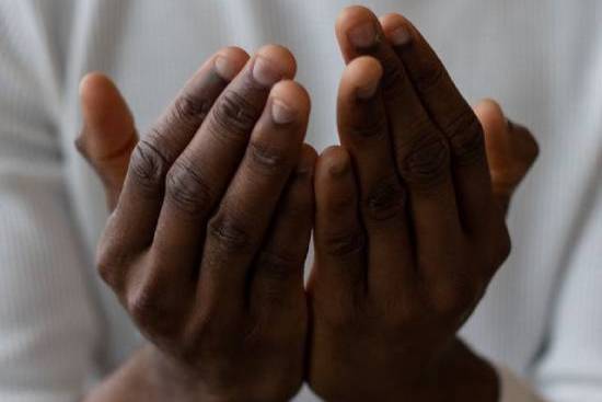 Mans Hands Praying Hands uplifted in prayer