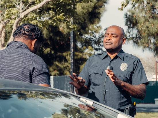 A policeman talking to a car driver A police officer speaking to a car driver