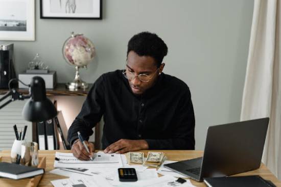 a man planning and budgeting to ensure his finances are put to good use.