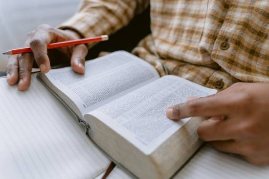 A Person Studying Scriptures A person studying Scrptures to find encouraging promises that offer reassurance and hope.