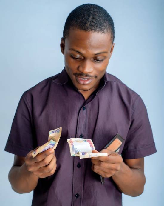 A man holding money in his hands. Couples should be open about their financial situation and take steps towards their goals.