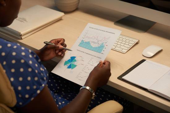 A woman analyzing data reports
