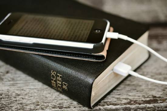 A Bible and an iPhone A Bible and an iPhone with a Bible app.