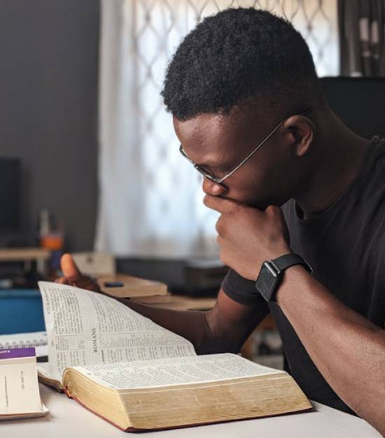 A Young Man Studying the Bible A young man studying the Bible to find insights on God's purpose for his life.