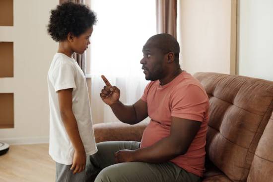 Father Scolding His Son An angry father scolding and reminding his sons of the rules and regulations at home.
