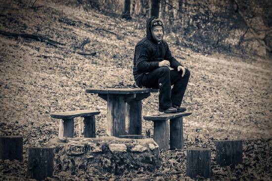 A Man Resting A man resting in a park as part of his bodily care routine.