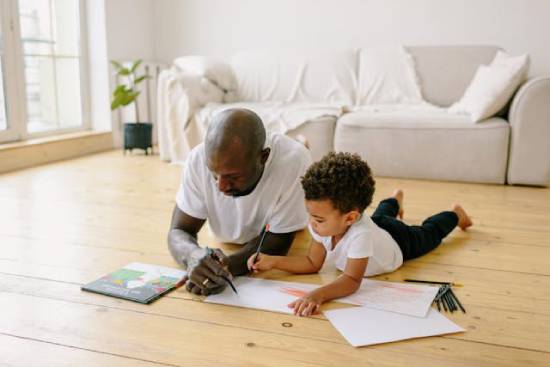 A father and a son drawing as part of traditions to stay away from tech and electronics.