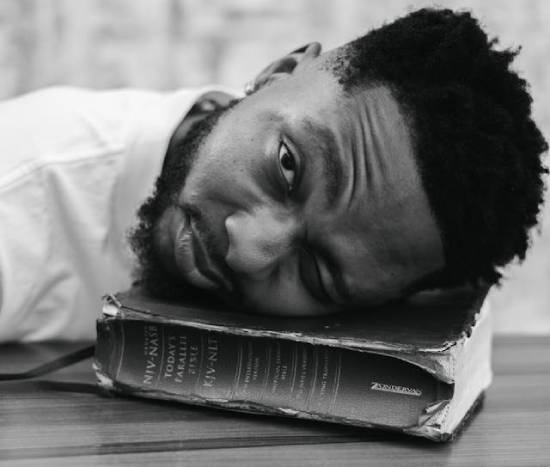 A Man Laying His Head on the Bible A man laying his head on a closed Bible, thinking about forgiveness.