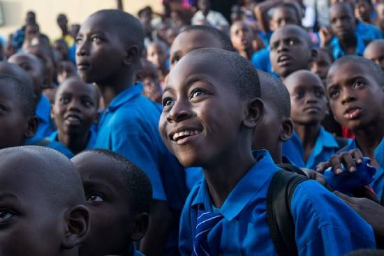 Attentive school kids listening carefully as they are taught about money management.