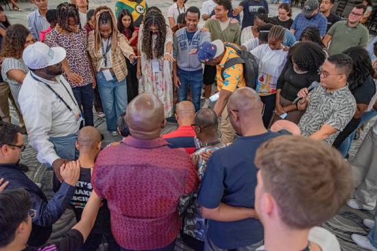 Christian believers praying together as a way of remaining spiritually strong.