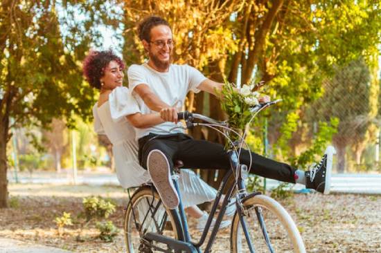 Couple Riding a Bike A couple riding a bike during their date as part their intentional efforts to rekindle emotional and physical intimacy.