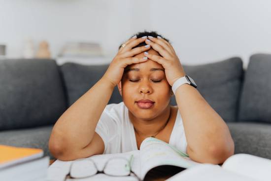 A woman practising mindful meditation at home to help her relieve stress.