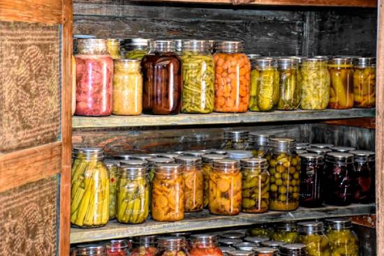 A wooded shelf filled with jars of ready to eat foods to help save time.