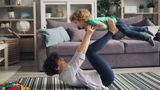 Woman holding a Child in the Air Woman holding a child in the air to exercise and play with her child.