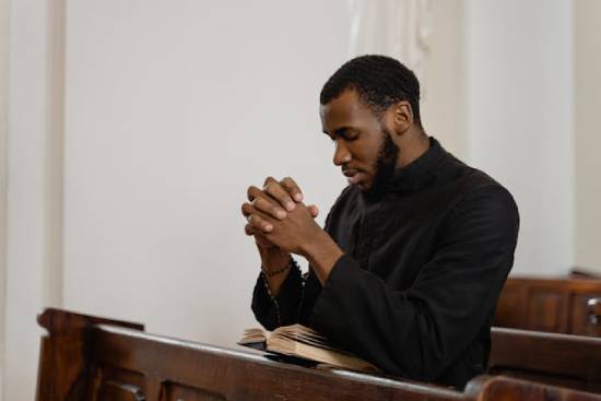 A man meditating on Bible promises as he seeks God in prayer.