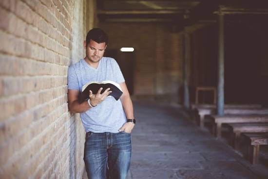 A man reading the Bible to find out what the Bible says about financial peace and decision-making.