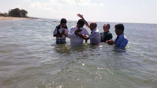A pastor baptising new converts to start a new journey with God.
