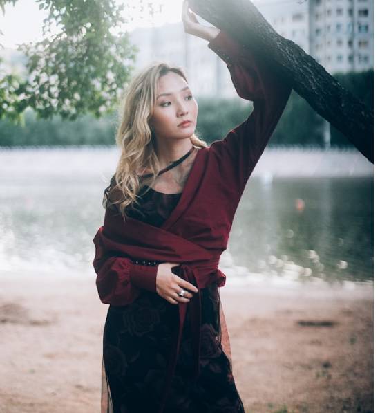 A Young Woman Tired of Singlehood A tired young leaning on a tree and lost in deep thoughts.