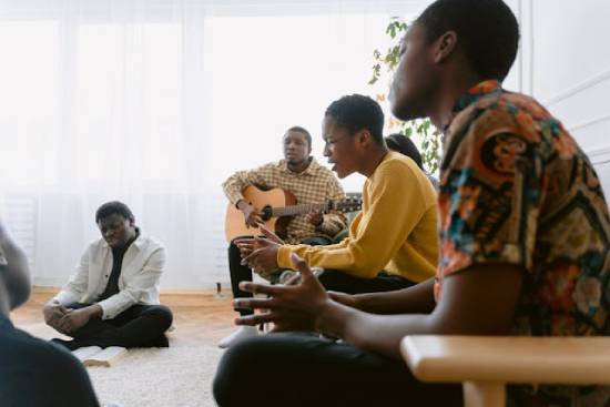 Christians who are members of a prayer band meeting together for Bible study, worship, and prayer.
