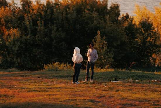 A couple enjoying a fall evening outdoors at sunset.