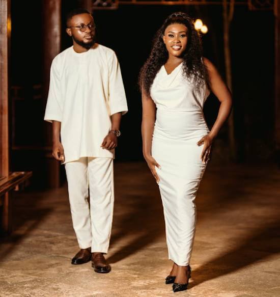 An elegant couple dressed in white in a dinner date.