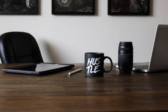 Side Hustle Equipment on a Desk Branded mug and side hustle equipment on a working desk.