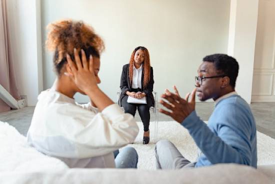A quarrelling couple seeking the services of a professional psychotherapist.