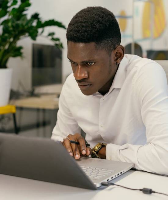 A Focused Man A focused man working on his laptop.