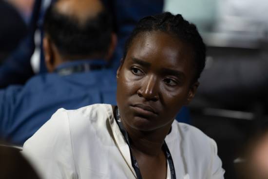 A woman keenly listening to a presentation on God's plan.