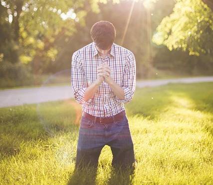 A prayerful man kneeling in prayer to seek God's guidance for his life.