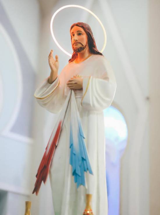 A calm figure of Jesus Christ with a halo of glory about his head.