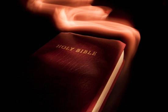 Holy Bible wrapped in a glowing halo of glory.