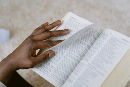 A person flipping the pages of the Bible to learn about boundaries.