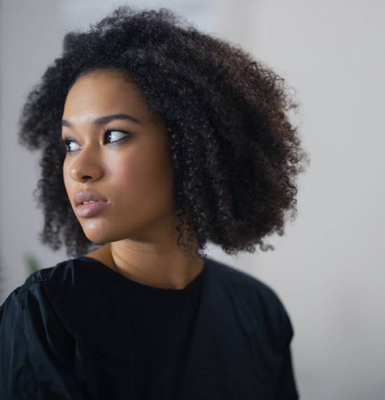 Thoughtful Woman A thoughtful woman in black dress looking over her shoulder.