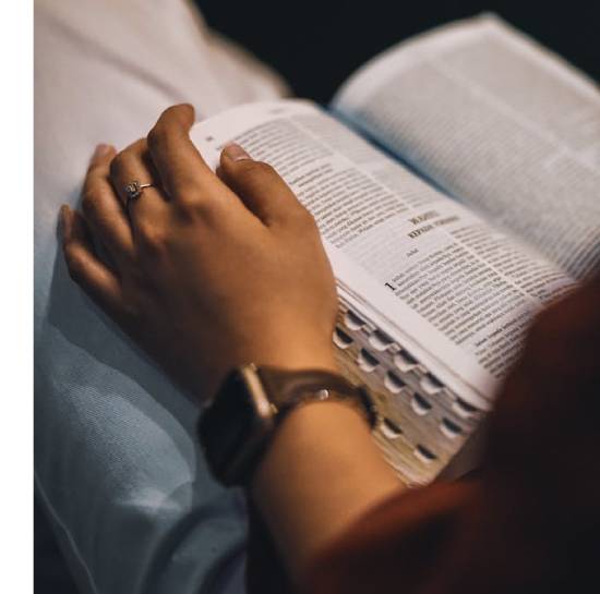 A close up pictorial representation of a person studying the bible.