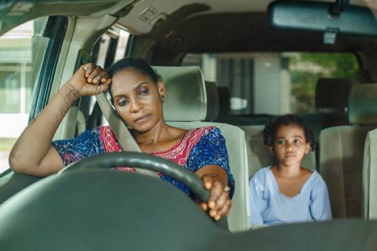 A disturbed mother opening up to her daughter while travelling together in a car.