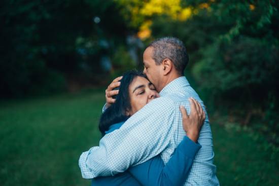 Hugging Couple A couple hugging in the park after solving their issues.