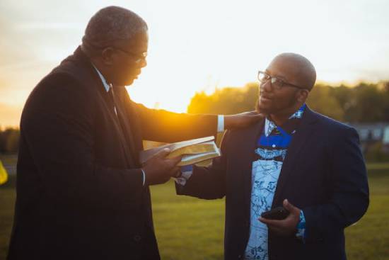 A preacher gently and calmly explaining scripture to an eager seeker of truth.