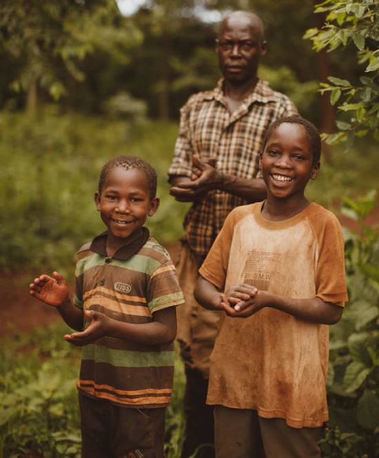 Boys and Father in the Farm Two smiling boys standing with their father in the firm.
