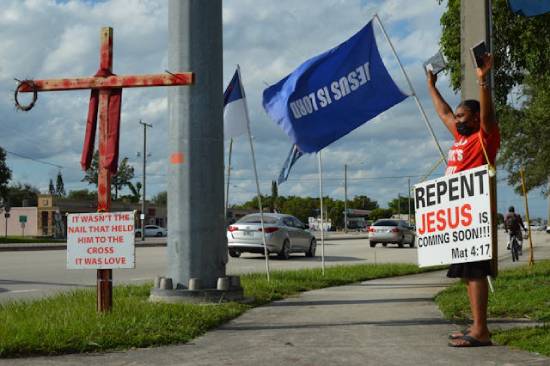 Zealous christains holding placrds with a message calling for repentance.