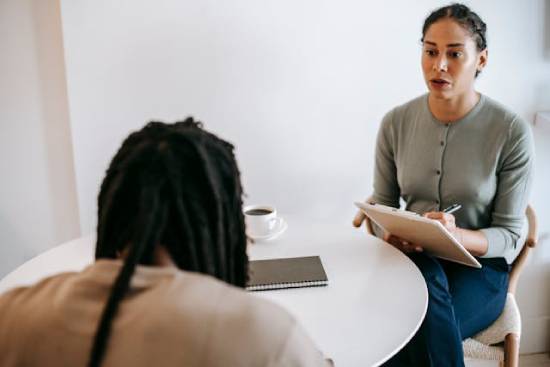 A man in dreadlocks having a psychotherapy session.