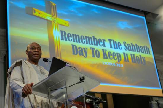 A preacher standing on the podium delivering a sermon on the benefits of a sabbath rest.