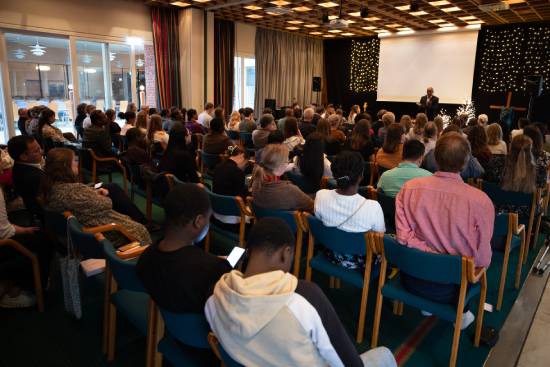 Congregants listening as a preacher presents a sermon on what the Bible says about fear, worry, and trusting in God.