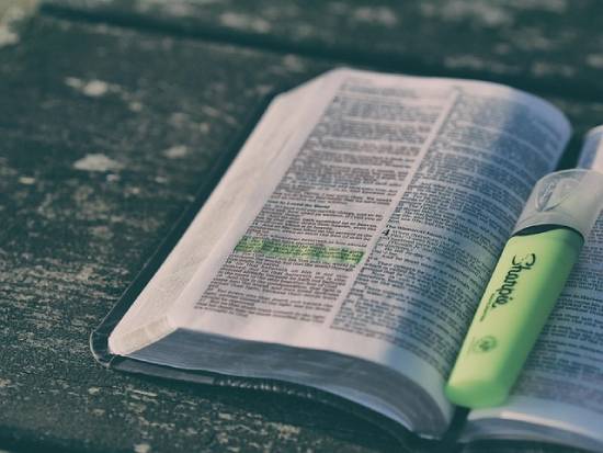 Open Bible An open highlighted Bible with a luminous green highlighter.