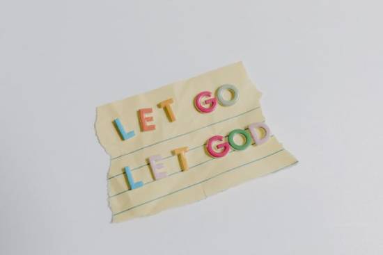 'Let Go Let God' Affirmation 'Let go Let God' affirmation written on teared notebook.