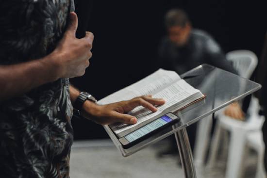 A preacher standing at the podium delivering a sermon on what the Bible says about uncertainty and trusting God.