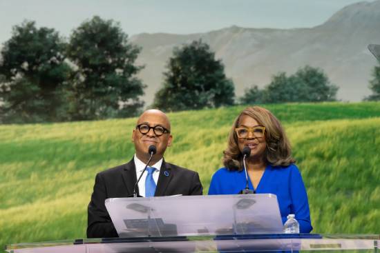 A couple delivering a presentation on love and emotional mayurity on a podium.
